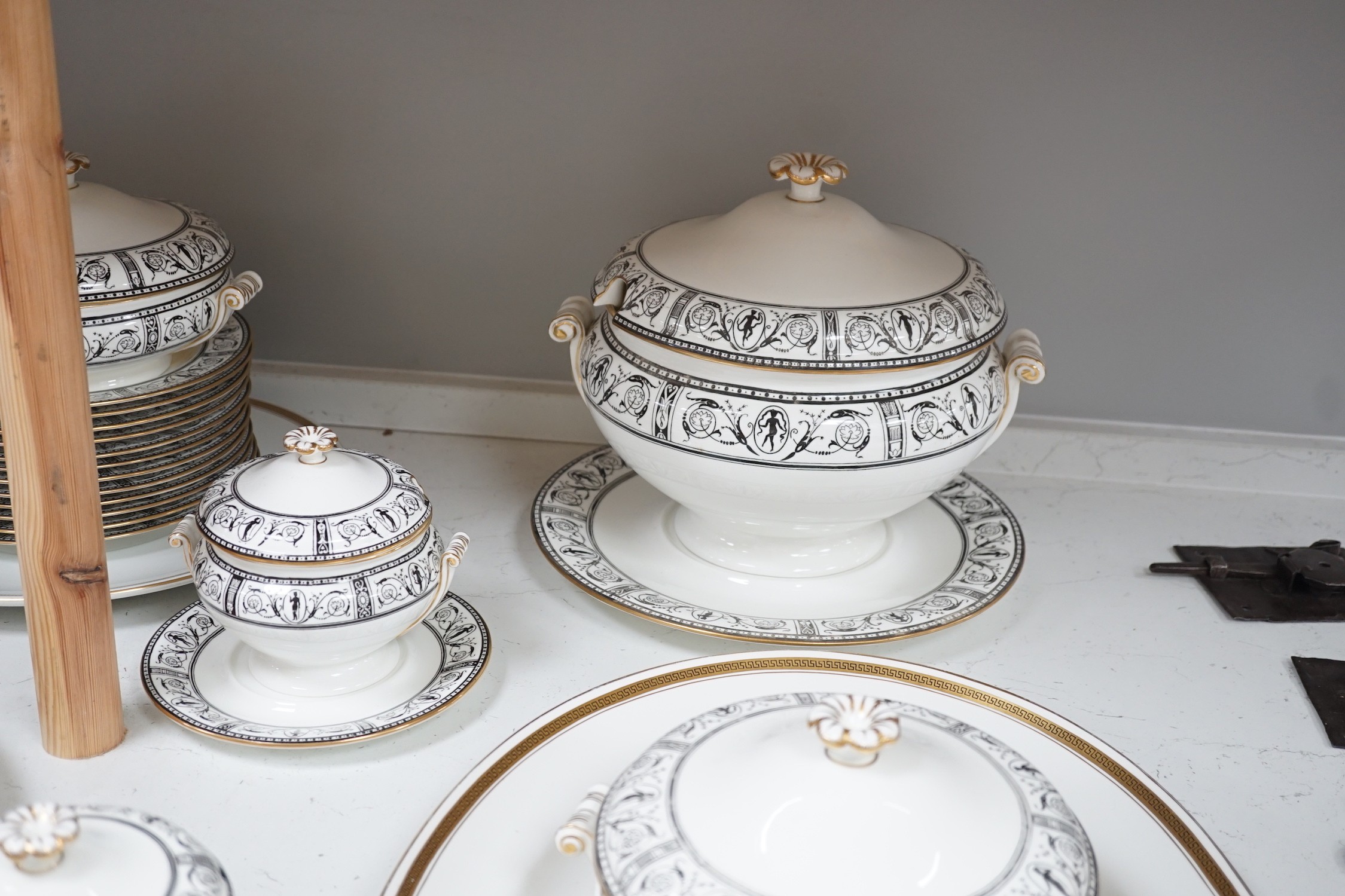 A Victorian Wedgwood part dinner service, with black printed classical borders, together with two Minton meat dishes and a Wedgwood gilt bordered coffee service.